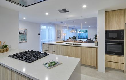 The kitchen in The Mahala display home by Blueprint Homes showing the view from the stovetop into the open plan living and dining areas